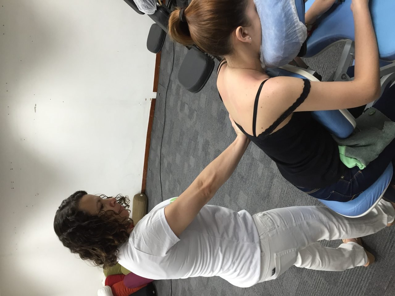 Colaboradores recebendo quick massage em cadeira ergonômica durante evento corporativo, no Rio de Janeiro — serviço de massagem expressa para empresas e SIPAT.